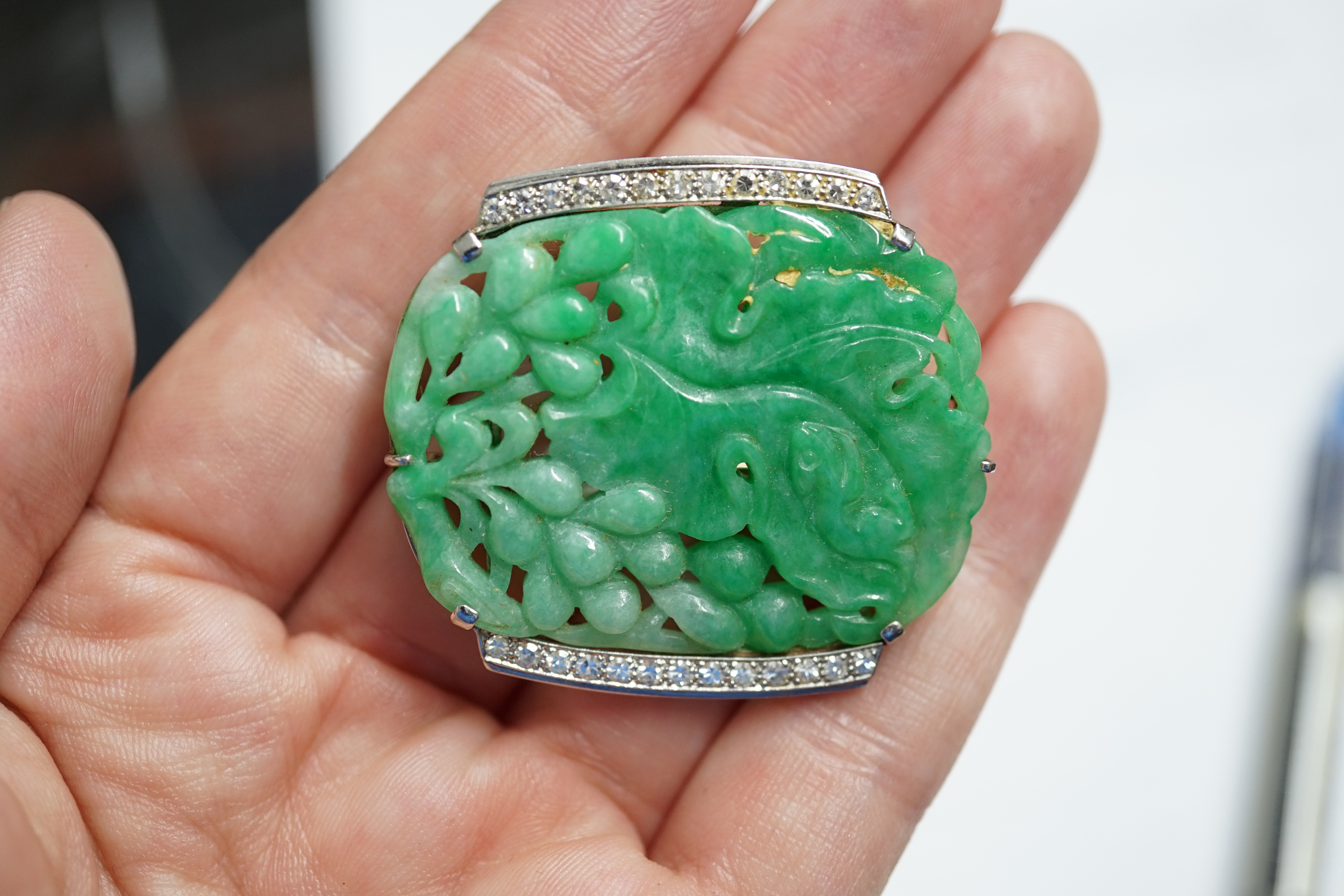 A Chinese white gold and diamond cluster set carved jade leaf and fruit brooch